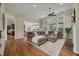 Spacious living room with hardwood floors, tall windows, comfortable seating and a fireplace at 2972 Riverwood Dr, Mount Pleasant, SC 29466