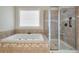 Modern bathroom featuring a jacuzzi tub and a glass-enclosed shower with tiled walls at 2972 Riverwood Dr, Mount Pleasant, SC 29466