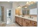 Spacious bathroom with a double vanity, a shower, and a door leading to the closet at 2972 Riverwood Dr, Mount Pleasant, SC 29466