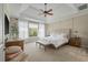 Serene bedroom retreat featuring a tray ceiling, soft natural light, and cozy carpet at 2972 Riverwood Dr, Mount Pleasant, SC 29466