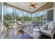 Comfortable screened porch with cozy furniture and a ceiling fan that offers views of the landscaped backyard at 2972 Riverwood Dr, Mount Pleasant, SC 29466