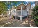 Back porch featuring stairs, a white railing, and a lattice design foundation at 3009 Macbeth Creek Dr, Charleston, SC 29414