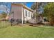 Backyard of the home featuring a green lawn, black fence, and lots of vegetation at 3009 Macbeth Creek Dr, Charleston, SC 29414