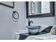 Stylish bathroom with a bowl sink atop the vanity and framed mirror at 3009 Macbeth Creek Dr, Charleston, SC 29414