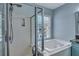 This bathroom features a soaking tub and glass shower with a window at 3009 Macbeth Creek Dr, Charleston, SC 29414