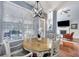 Cozy dining area with a chandelier, wood table, and chairs offering a view to the outside at 3009 Macbeth Creek Dr, Charleston, SC 29414