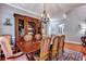 Formal dining room showcasing a large wooden table, chandelier, and built-in hutch at 3009 Macbeth Creek Dr, Charleston, SC 29414