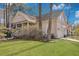 Charming home featuring a covered porch, well-maintained lawn, and attached garage at 3009 Macbeth Creek Dr, Charleston, SC 29414