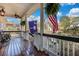 Front porch displaying American and South Carolina flags and hanging fern plants at 3009 Macbeth Creek Dr, Charleston, SC 29414