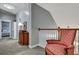 Hallway landing with a decorative chair, wood railing, and a carpeted floor at 3009 Macbeth Creek Dr, Charleston, SC 29414