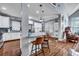 Open-concept kitchen with island seating, white cabinets, and stainless steel appliances at 3009 Macbeth Creek Dr, Charleston, SC 29414