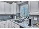 Well-lit kitchen features granite countertops, subway tile backsplash, and stainless steel sink at 3009 Macbeth Creek Dr, Charleston, SC 29414