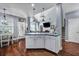 Open kitchen with a center island, wooden floors, and dining area in background at 3009 Macbeth Creek Dr, Charleston, SC 29414