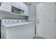 Functional laundry room with cabinets and white front-loading washer and dryer at 3009 Macbeth Creek Dr, Charleston, SC 29414