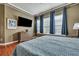 This main bedroom features hardwood floors, curtains, a dresser, and a TV at 3009 Macbeth Creek Dr, Charleston, SC 29414