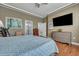 This main bedroom features wood floors, a ceiling fan, a TV, and neutral colored walls at 3009 Macbeth Creek Dr, Charleston, SC 29414