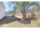 Fenced backyard featuring a lush lawn, palm trees, and mature trees at 3042 Moonlight Dr, Charleston, SC 29414