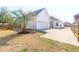 Spacious backyard with well-maintained lawn, mature trees, and a private driveway to a two-car garage at 3042 Moonlight Dr, Charleston, SC 29414