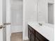 Clean bathroom featuring a dark-wood vanity, white countertop, framed mirror, and shower/tub combination at 3042 Moonlight Dr, Charleston, SC 29414