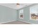 Bedroom with fresh, light-blue walls, carpet, ceiling fan, and two windows to let in natural light at 3042 Moonlight Dr, Charleston, SC 29414