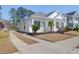 Inviting curb appeal with a manicured lawn and landscaped front yard with a long private drive at 3042 Moonlight Dr, Charleston, SC 29414