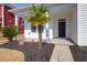 Inviting front porch with palm trees, black mulch, and manicured lawn at 3042 Moonlight Dr, Charleston, SC 29414