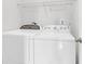 Bright laundry area features a side by side washer and dryer and storage shelving above at 3042 Moonlight Dr, Charleston, SC 29414