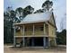 Charming raised home featuring a welcoming porch, elevated design, and classic architectural details at 3102 Hailey Ct, McClellanville, SC 29458