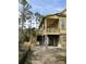 Side view of a raised home featuring a spacious porch and elevated design at 3102 Hailey Ct, McClellanville, SC 29458