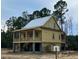 Elegant raised home featuring a spacious porch, elevated design, and classic architectural details at 3102 Hailey Ct, McClellanville, SC 29458