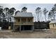 Charming raised home with a spacious porch, elevated design, and inviting architectural details at 3102 Hailey Ct, McClellanville, SC 29458