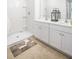 Bright bathroom with double sinks, white cabinets, and a walk-in shower with decorative rug at 315 Pine Crest View Dr, Summerville, SC 29486