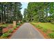 Paved trail for walking and biking with adjacent benches surrounded by nature at 315 Pine Crest View Dr, Summerville, SC 29486