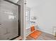 Bright bathroom featuring a glass-enclosed shower, soaking tub, and stylish orange accents at 315 Sabal Palmetto Ct, Moncks Corner, SC 29461
