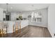 Bright breakfast nook with hardwood floors, counter seating, and natural light at 315 Sabal Palmetto Ct, Moncks Corner, SC 29461