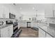 Modern kitchen with stainless steel appliances, white cabinetry, and granite countertops at 315 Sabal Palmetto Ct, Moncks Corner, SC 29461