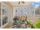 Cozy screened-in patio with stylish decor, providing a perfect space for relaxing and entertaining outdoors at 315 Sabal Palmetto Ct, Moncks Corner, SC 29461