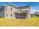 Backyard featuring a screened-in porch, manicured lawn, and siding on the house at 330 Pine Crest View Dr, Summerville, SC 29486