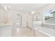 A pristine, well-lit bathroom features a soaking tub under a window and double sink vanity at 330 Pine Crest View Dr, Summerville, SC 29486