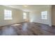 Serene bedroom featuring hardwood floors, natural light from three windows, and neutral color scheme at 330 Pine Crest View Dr, Summerville, SC 29486