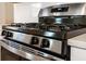 Close-up of a sleek stainless steel gas range with a black cooktop, oven, and easy-to-use controls at 330 Pine Crest View Dr, Summerville, SC 29486