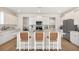 Bright, modern kitchen with white cabinets, stainless steel appliances and a spacious island with seating at 330 Pine Crest View Dr, Summerville, SC 29486