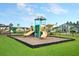 Community playground with slides and swings, with well maintained lawn and black fencing at 330 Pine Crest View Dr, Summerville, SC 29486