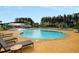 Community pool with tanning chairs and umbrellas offers a great way to cool off on a warm day at 330 Pine Crest View Dr, Summerville, SC 29486