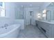 Luxurious bathroom featuring a soaking tub, glass-enclosed shower, and a double vanity with elegant fixtures at 3897 Summerton St, Mount Pleasant, SC 29466