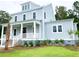 Charming two-story home with a covered front porch and a well-manicured lawn at 3897 Summerton St, Mount Pleasant, SC 29466
