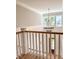 Stairway landing features a contemporary chandelier and natural light from the adjacent windows at 3897 Summerton St, Mount Pleasant, SC 29466