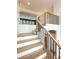 Beautiful staircase with white risers, wood treads, and a black metal railing leading to a second floor landing at 3897 Summerton St, Mount Pleasant, SC 29466