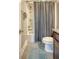 Bathroom with tiled floor, shower-tub combo, and decorative gray shower curtain at 3941 Four Poles Park Dr, North Charleston, SC 29405