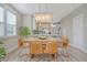 Dining area with a large rustic wooden table and a modern, decorative light fixture at 3941 Four Poles Park Dr, North Charleston, SC 29405